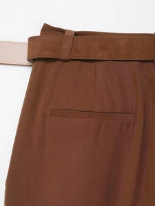 Detailed close-up of dark brown trousers waist with matching belt and rear welt pocket