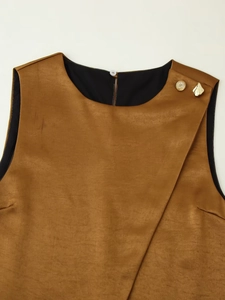 Detail of camel brown vest with asymmetrical overlap design and gold decorative buttons