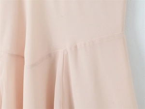 Close-up of light pink chiffon fabric showing high-quality stitching and elegant drape