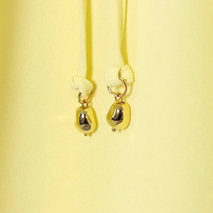 Elegant gold irregular cord ends on minimalist drawstring shirt with lantern sleeves