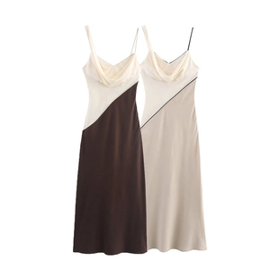 Detail of satin slip midi dresses featuring cowl necklines and contrast stitching