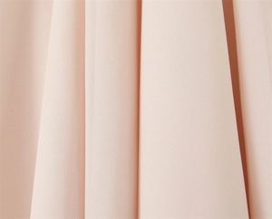 Detail view of light pink chiffon fabric with elegant micro-texture and soft drapes