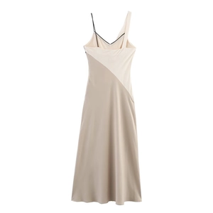 Detail view of the asymmetric neckline and two-tone satin fabric of the summer dress