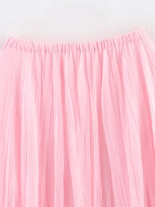 Detailed view of pink mesh skirt showing elastic waistband and ruched fabric texture