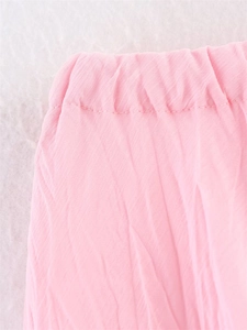Close-up of pink mesh skirt elastic waistband featuring pleated fabric and neat stitching