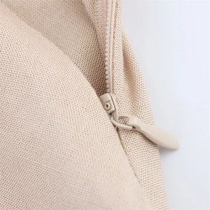 Detailed close-up of beige summer dress featuring seamless invisible zipper and fabric texture