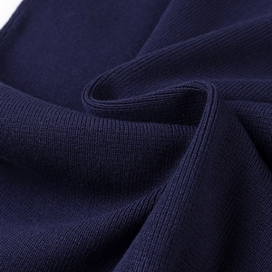 Detailed close-up of dark navy rib-knit fabric texture with high density stitching