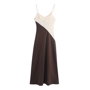 Detail view of the asymmetric strap design on a two-tone patchwork summer dress