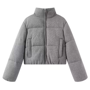 Detail of the gray quilted puffer jacket featuring a warm stand collar and zip closure