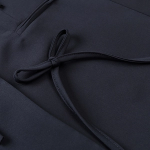 Women's dark navy blazer with a decorative bow design and premium woven fabric texture