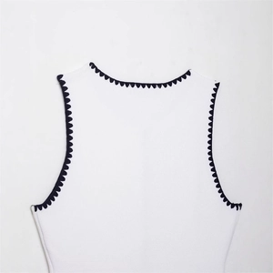 Women's white sleeveless knit vest featuring elegant black wavy contrast trim and texture