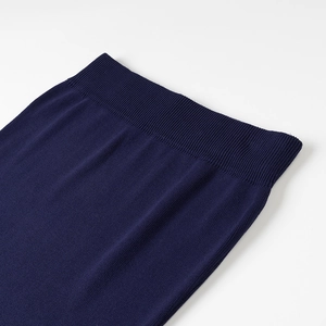 Detailed close-up of dark blue ribbed elastic waistband on women's knit skirt set