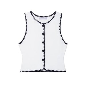 Women's white sleeveless knit vest with black wavy trim and button front detail