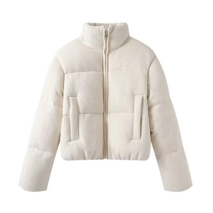 Macro detail of creamy white padded jacket with textured knit fabric and zip closure