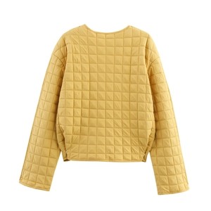 Back view detail of yellow quilted jacket showing grid stitching and round neck