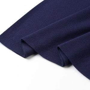 Detailed close-up of navy blue ribbed knit fabric showing texture on two piece dress