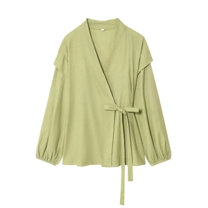 Detailed view of sage green tie-front blouse featuring soft cotton linen fabric texture