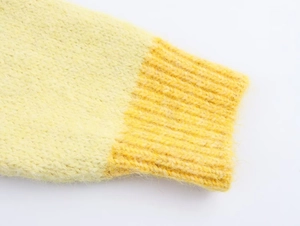 Detail of yellow knit cardigan cuff with soft fuzzy mohair texture and ribbed trim