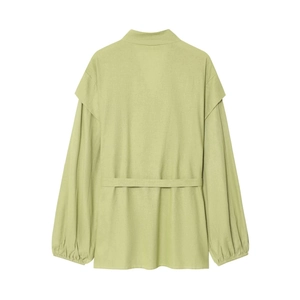 Detail view of the back of a light green puff sleeve blouse with textured fabric and belt