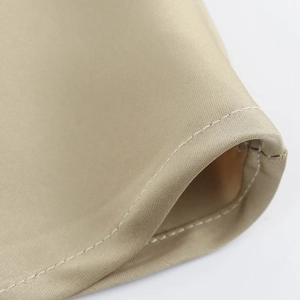 Detailed view of fine stitching and silky satin fabric texture on a midi dress hemline