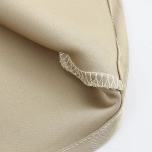 Detailed close-up showing the precise overlock stitching and hem of the satin midi dress