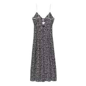 Detail of V-neckline floral sundress with delicate white bow tie and thin straps