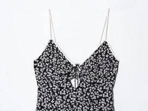 Close-up of V-neckline with drawstring detail and floral print on summer dress