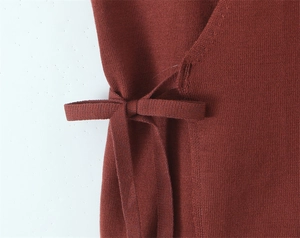 Detail shot of the brown knitted halter top featuring side lace-up bow and fine texture