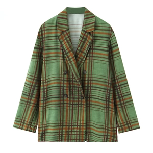 Close-up of retro green plaid blazer showing peaked lapels and four dark brown buttons