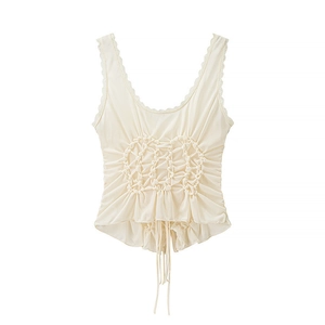 Detail of cream pleated tank top featuring lace trim and adjustable drawstrings