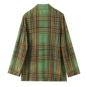 Detail of green plaid flannel shirt showing texture, fabric pattern and collar design