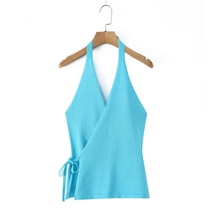 Detail view of light blue wrap halter knit top with side bow tie on a wooden hanger