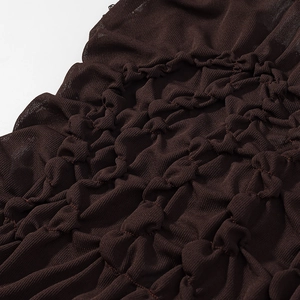 Detail of dark brown ruched fabric showing the intricate elastic smocking texture