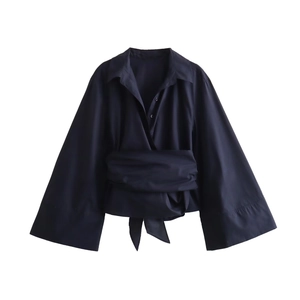 Detail of navy long sleeve shirt with wide cuffs and wrap-around tie-waist design