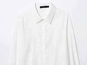 Detailed view of crisp white button-down shirt collar and premium fabric texture