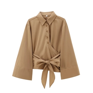 Detail of khaki long sleeve blouse with waist wrap design and elegant large bow tie