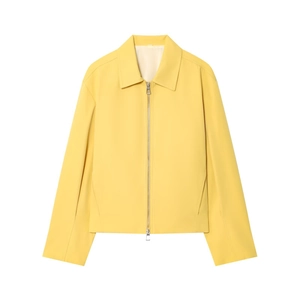 Detail of pale yellow zip-up jacket with lapel collar and silver metallic two-way zipper