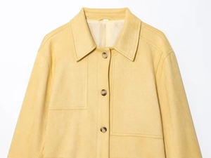 Detail of ginger faux suede jacket featuring lapel collar, single-breasted buttons and pockets