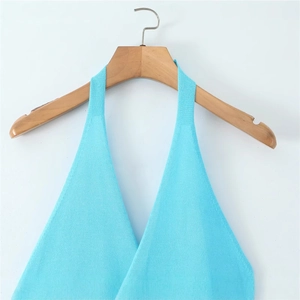 Light blue knitted halter top with cross V-neck design hanging on a wooden hanger