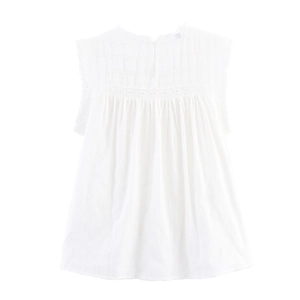 Detail of white sleeveless cotton top featuring delicate lace trim and embroidered texture