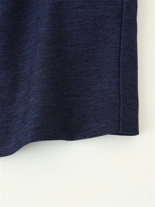 Macro detail of navy blue twill fabric texture and stitching for elegant women's trousers