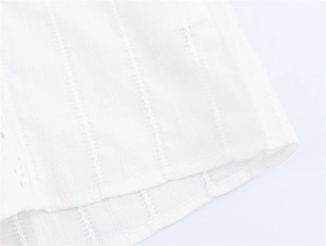 Detailed macro view of white ribbed fabric with elegant hollow out lace trim and texture