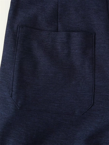 Detail of dark blue patch pocket with precision stitching on a high-quality fabric