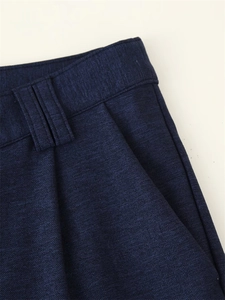 Detailed close-up of navy blue twill pants showing the waistband and side pocket texture