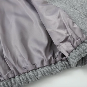 Detailed macro view of gray wool blend fabric with inner lining and elastic hem stitch