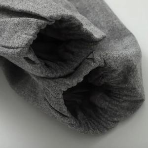 Detailed macro view of gray wool jacket sleeve with elastic cuff and premium lining