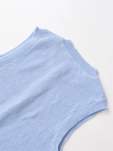 Close-up of light blue knit vest showing honeycomb texture and ribbed neckline detail