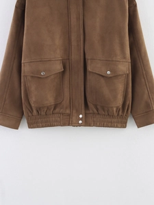 Detail of brown suede bomber jacket featuring large flap pockets and elastic hem design