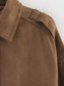 Detailed view of dark brown faux suede jacket collar and shoulder stitching texture