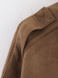 Detail of brown faux suede jacket shoulder strap with reinforced cross stitching